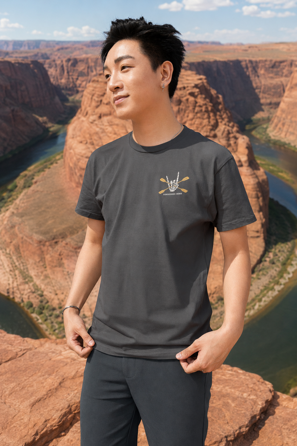 Man wearing a Solid Asphalt Blend Do You Wanna Play Horseshoes? T-shirt with small skeleton kayaker chest graphic at Horseshoe Bend