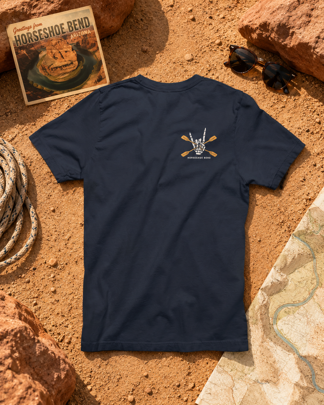 Heather Midnight Navy Do You Wanna Play Horseshoes? T-shirt with small skeleton kayaker chest graphic, flat lay with desert hiking gear