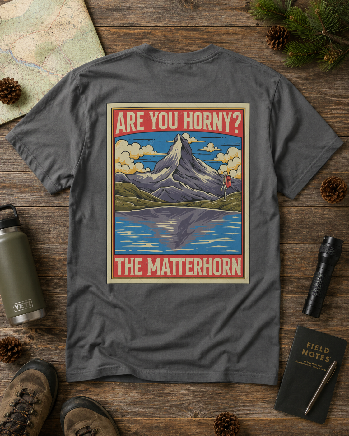 Are You Horny? Matterhorn graphic tee displayed on an outdoor hiking flat lay
